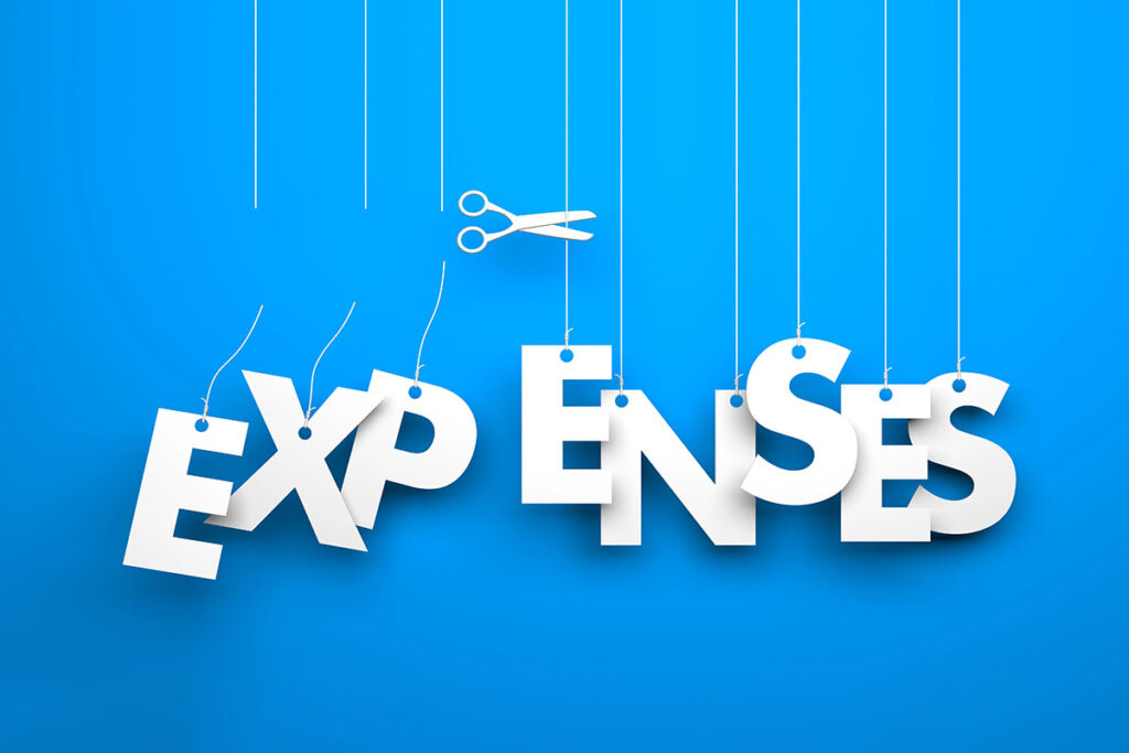 A pair of white scissors cuts the string holding up the letter "P" in the word "EXPENSES" against a bright blue background.