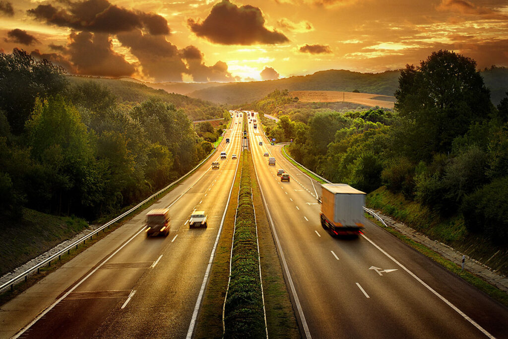 Areal photo of a highway at sunset.